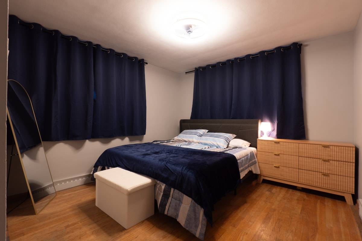 King bedroom with USB charging headboard, dresser and full-length mirror